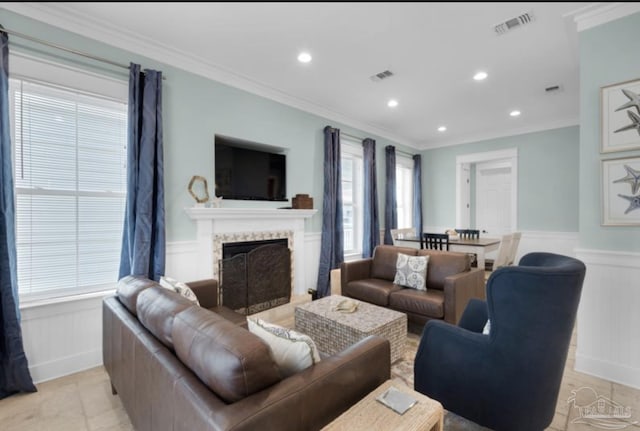 living room featuring a fireplace and crown molding