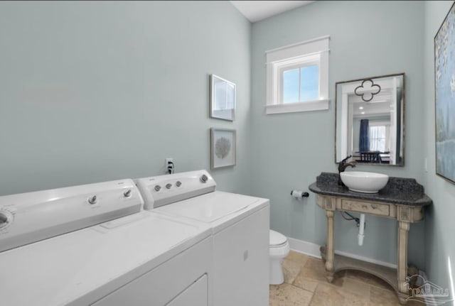 laundry room featuring washing machine and dryer and sink