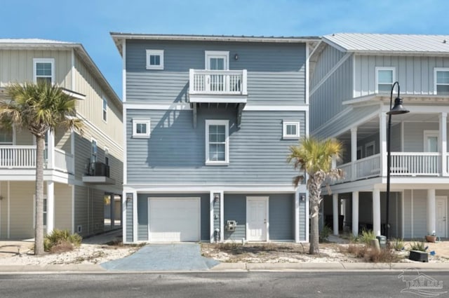 view of front of property with a balcony and a garage