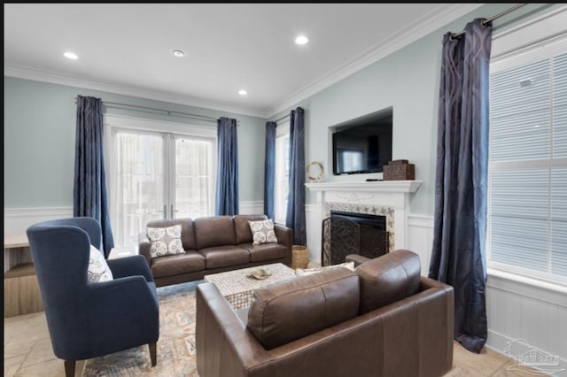 living room featuring crown molding and a premium fireplace