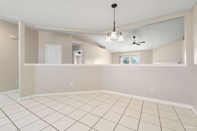 unfurnished room with vaulted ceiling, ceiling fan with notable chandelier, and baseboards