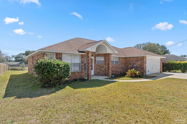 single story home featuring a garage, driveway, a front yard, and brick siding