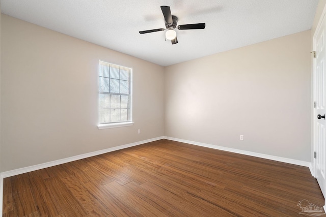 empty room with ceiling fan, baseboards, and wood finished floors