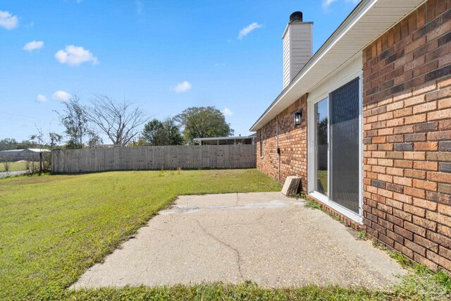 view of yard with a fenced backyard and a patio