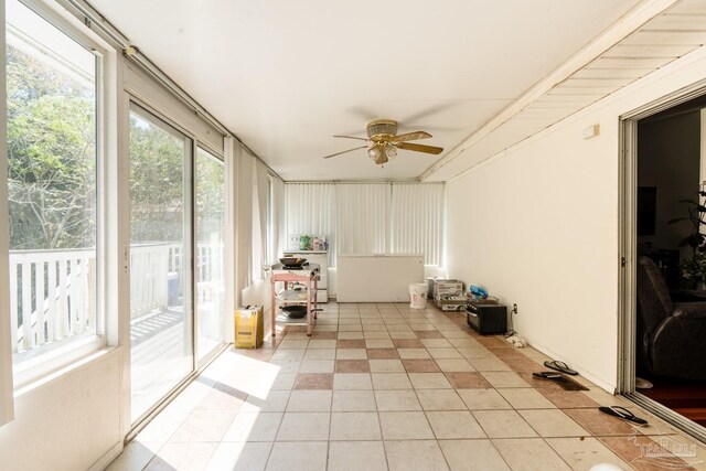 unfurnished sunroom featuring ceiling fan