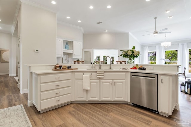 kitchen featuring a sink, crown molding, white cabinetry, stainless steel dishwasher, and light countertops
