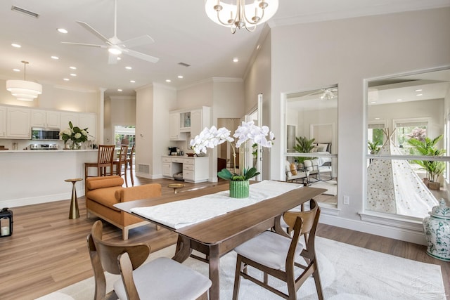 dining space with ornamental molding, visible vents, ceiling fan, and plenty of natural light