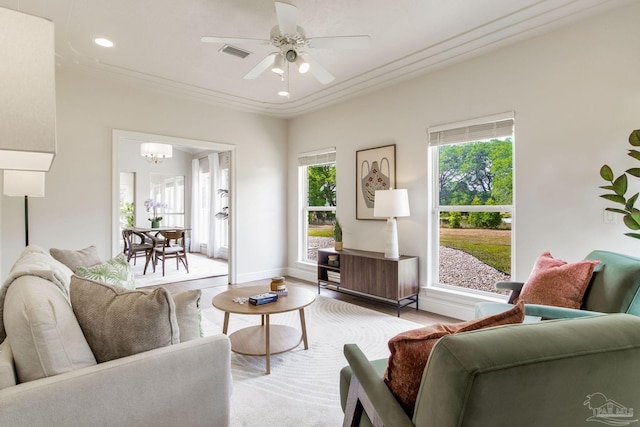 living area featuring ceiling fan with notable chandelier, visible vents, recessed lighting, baseboards, and light wood-style floors