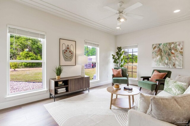 living area featuring a ceiling fan, baseboards, recessed lighting, and wood finished floors