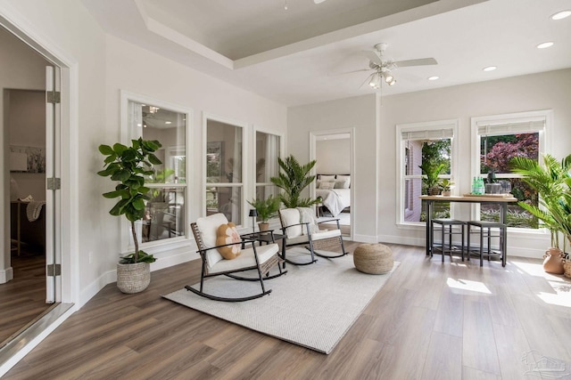 living area featuring a ceiling fan, baseboards, recessed lighting, and wood finished floors