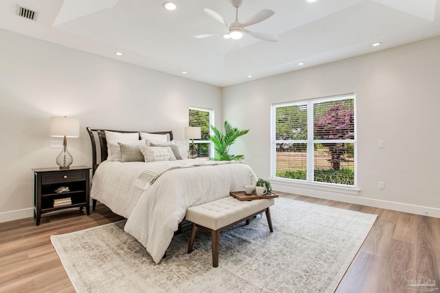 bedroom with baseboards, recessed lighting, light wood-style flooring, and visible vents
