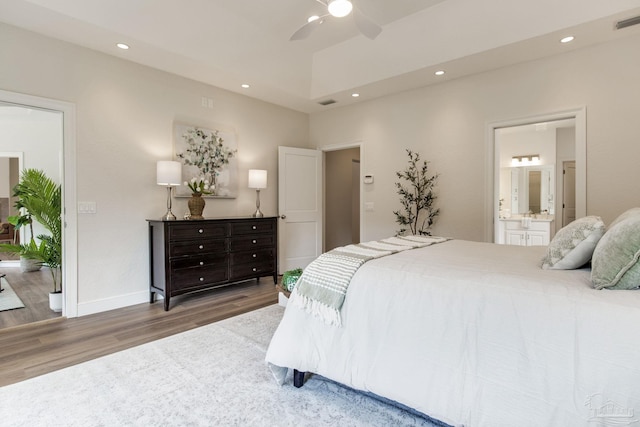 bedroom with wood finished floors, ensuite bath, visible vents, recessed lighting, and a ceiling fan