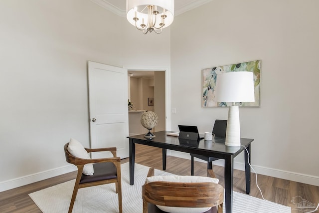 office featuring baseboards, ornamental molding, and wood finished floors