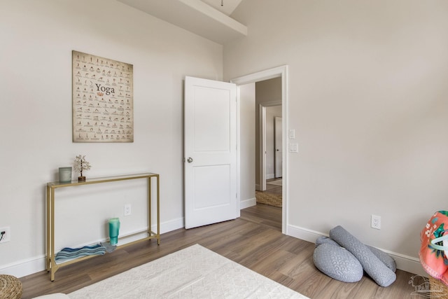 bedroom with baseboards and wood finished floors