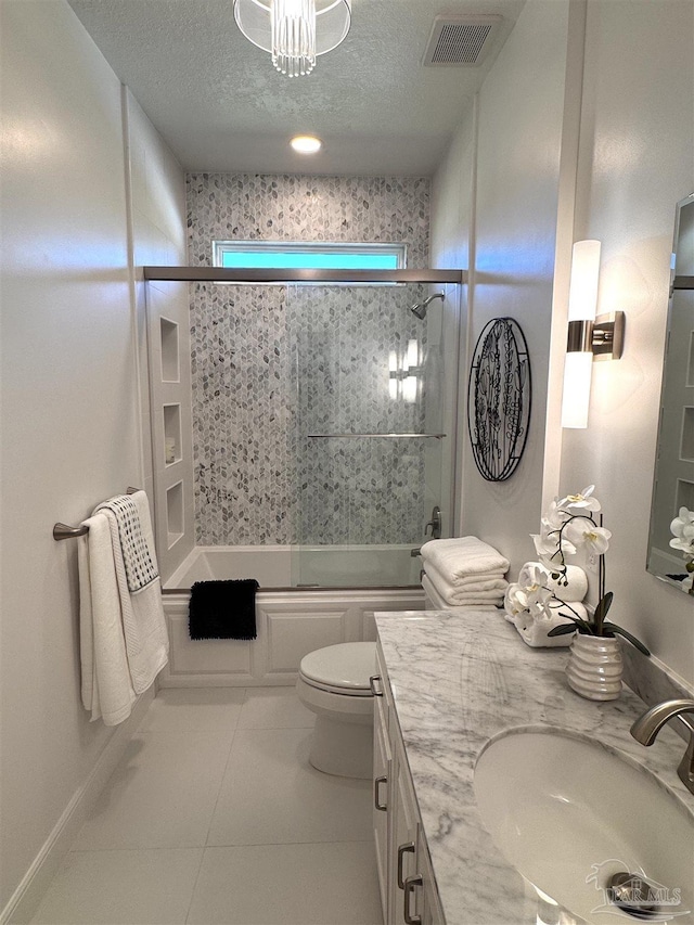 bathroom with toilet, a textured ceiling, visible vents, tile patterned flooring, and bath / shower combo with glass door