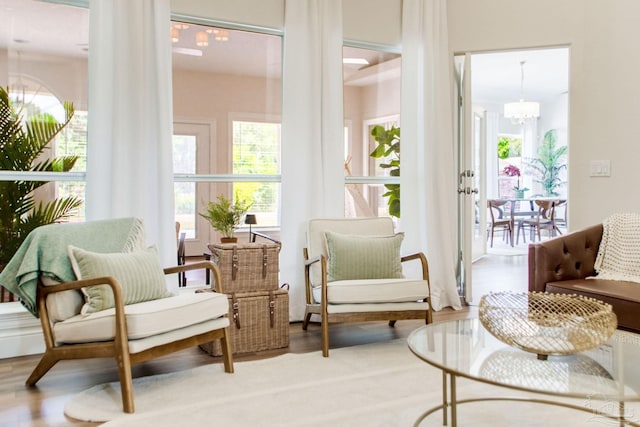sunroom / solarium featuring a wealth of natural light and a notable chandelier