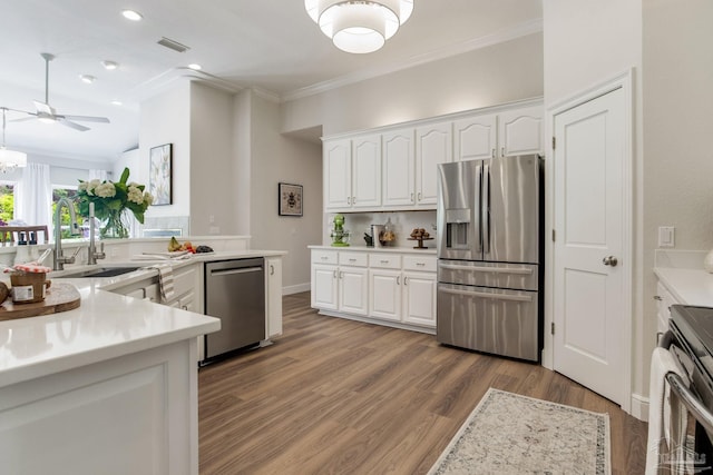 kitchen featuring a sink, stainless steel appliances, white cabinetry, visible vents, and light countertops