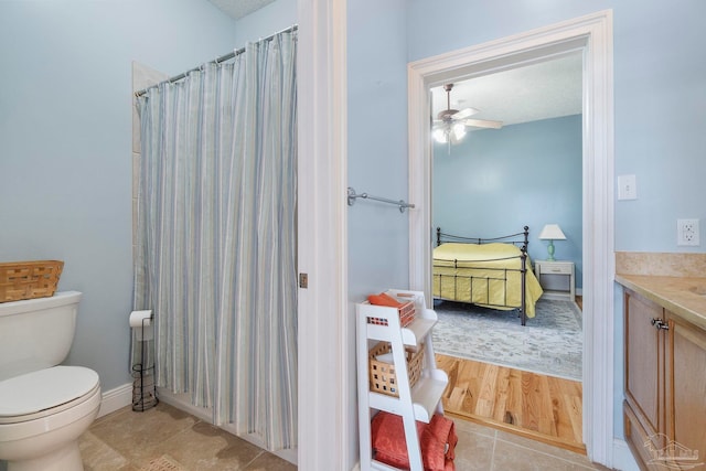 bathroom featuring tile patterned floors, toilet, vanity, and ceiling fan