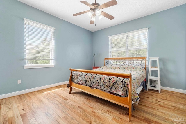 bedroom with ceiling fan and light hardwood / wood-style floors