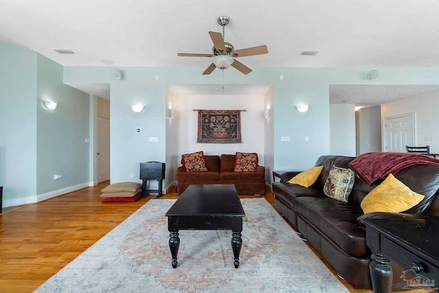 living room featuring light hardwood / wood-style floors and ceiling fan