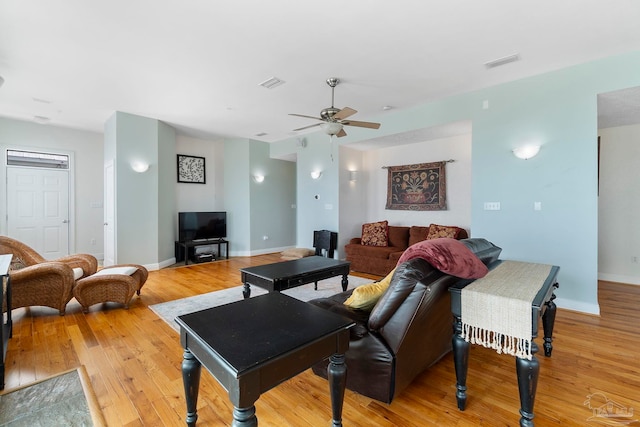 living room featuring ceiling fan and light hardwood / wood-style floors