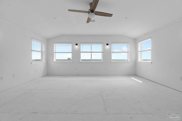 unfurnished room with lofted ceiling, ceiling fan, and plenty of natural light