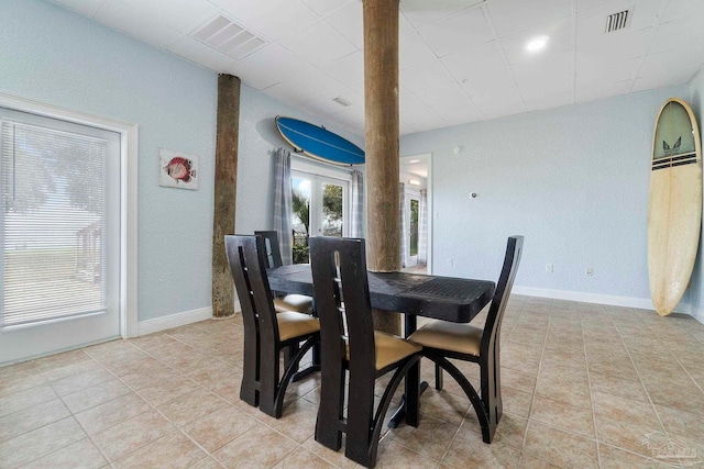 dining area featuring light tile patterned floors and french doors