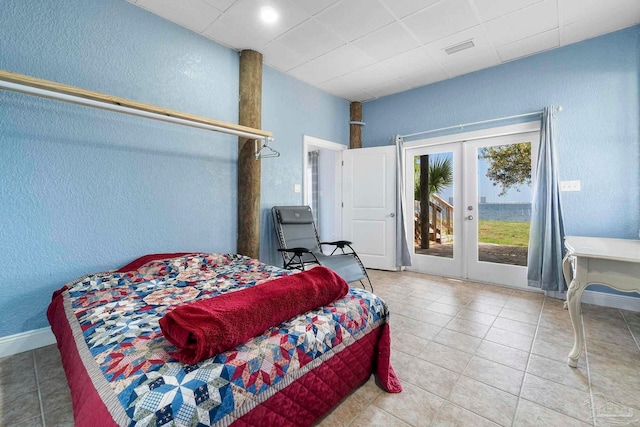 tiled bedroom with access to outside and french doors