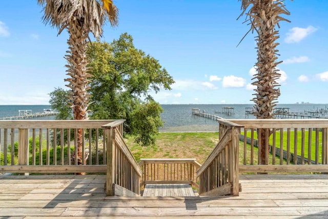 wooden terrace featuring a boat dock and a water view