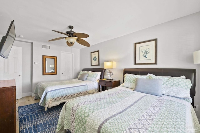 bedroom featuring ceiling fan and hardwood / wood-style flooring