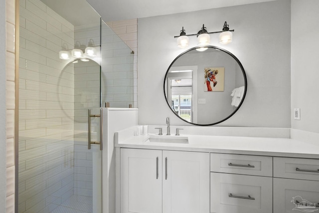 bathroom with a shower with shower door and vanity