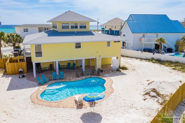 view of swimming pool featuring a water view and a patio area