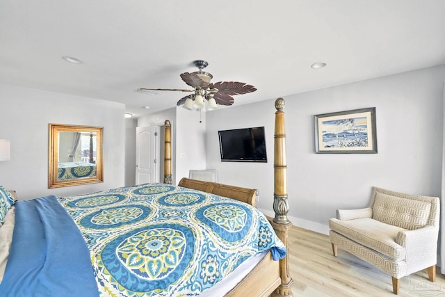 bedroom with ceiling fan and light hardwood / wood-style floors