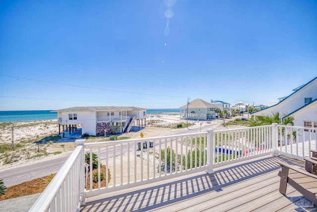 deck with a water view and a view of the beach