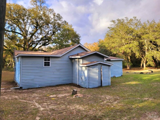 back of house with a yard