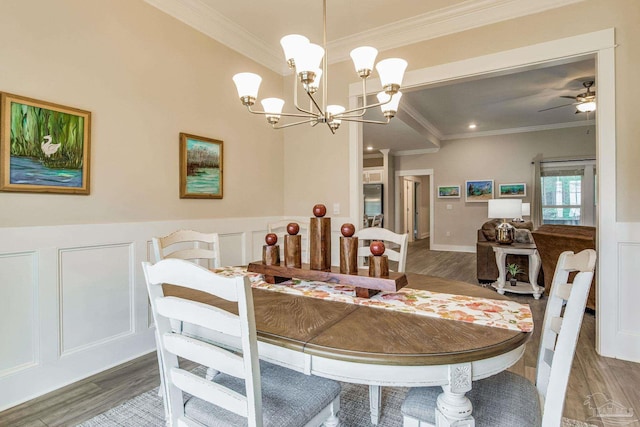 dining room with ornamental molding, ceiling fan with notable chandelier, dark hardwood / wood-style flooring, and beam ceiling