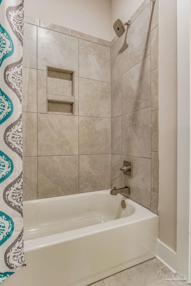 bathroom featuring shower / bath combo with shower curtain and tile patterned floors