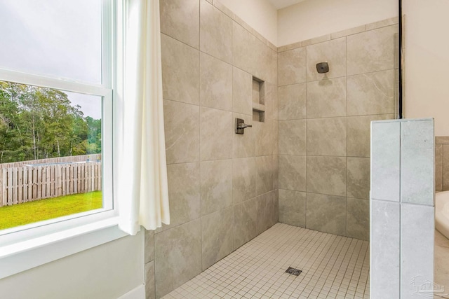 bathroom featuring tile patterned flooring and tiled shower