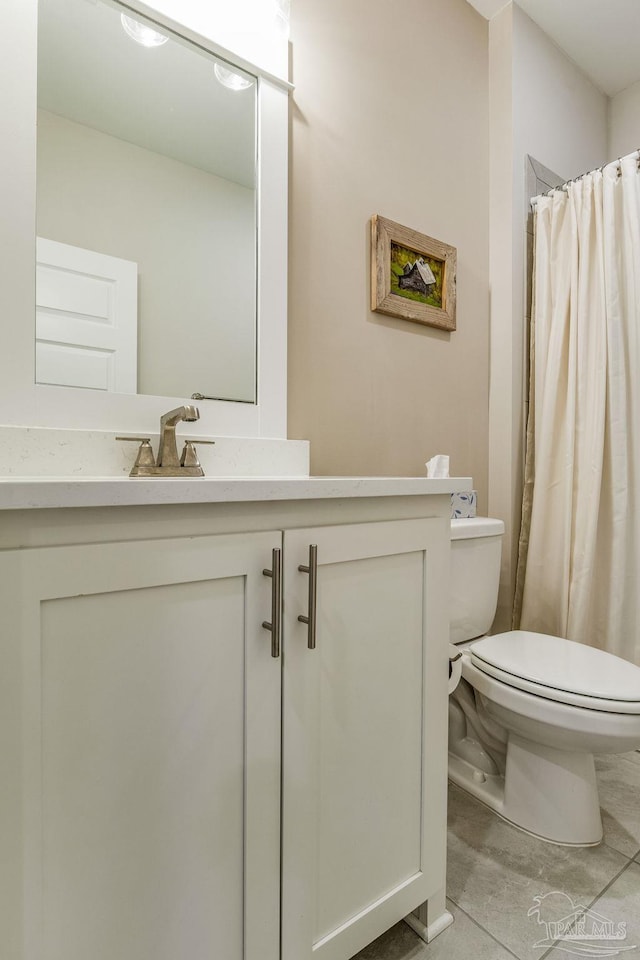 bathroom with walk in shower, tile patterned flooring, vanity, and toilet