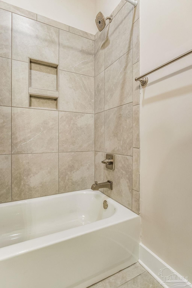 bathroom featuring tile patterned flooring and tiled shower / bath combo