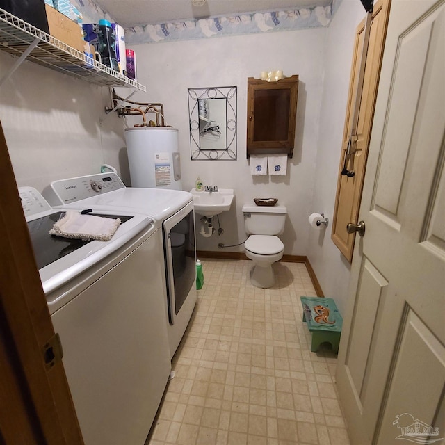 laundry room with washer and clothes dryer, light floors, baseboards, and electric water heater