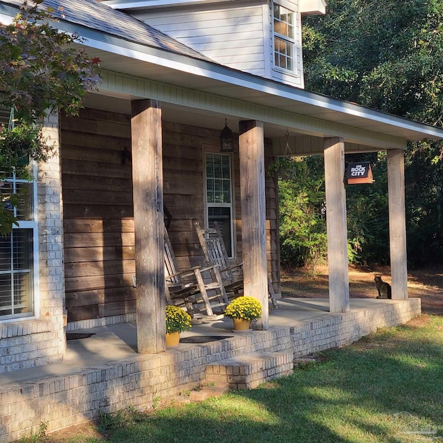 view of exterior entry with covered porch