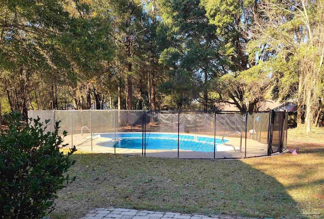 view of pool with a fenced in pool, a fenced backyard, and a lawn