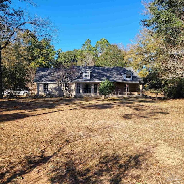 rear view of property with covered porch