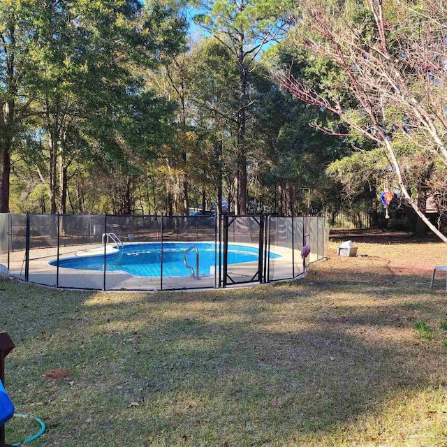 view of swimming pool with a lawn, a fenced in pool, and fence