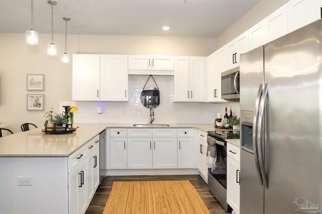 9668 Nature Creek Blvd, Pensacola, FL 32526 - kitchen with stainless steel appliances, a peninsula, dark wood finished floors, white cabinetry, and recessed lighting