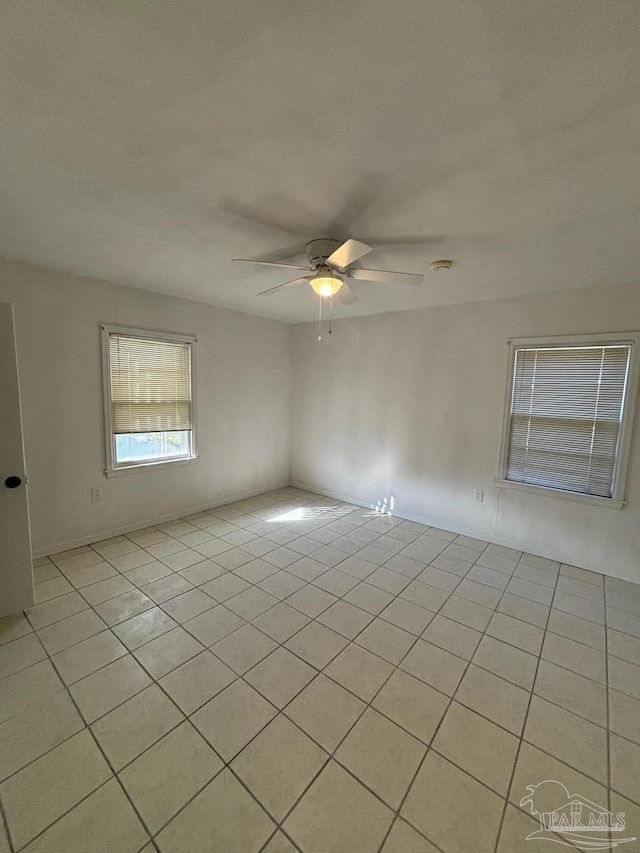 tiled empty room with ceiling fan