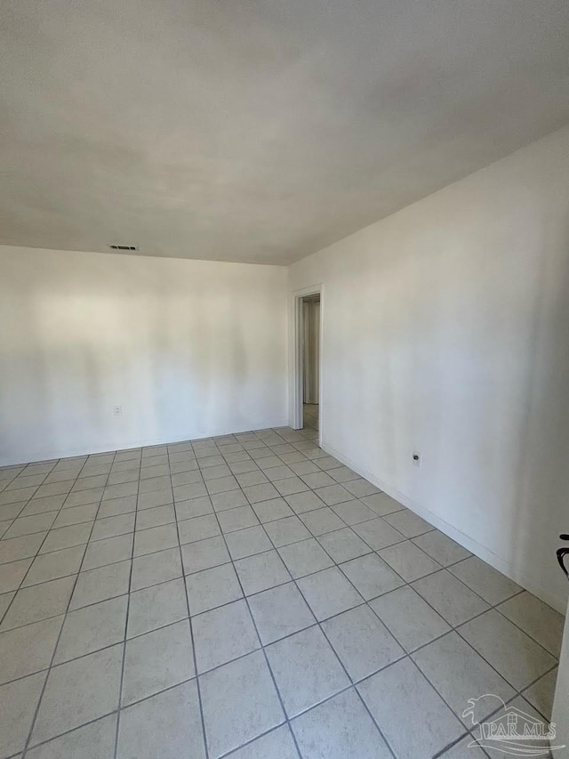 spare room featuring light tile patterned flooring