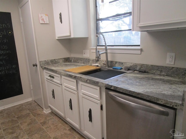 kitchen featuring stainless steel dishwasher, sink, light stone countertops, and white cabinets