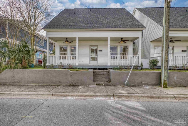 view of front of property with covered porch, ceiling fan, and roof with shingles